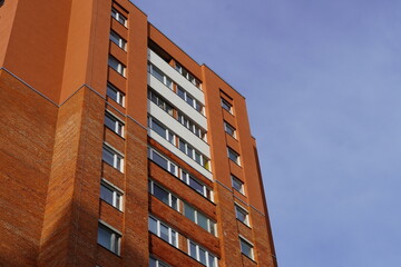 Looking up to red (orange) brick with many windows, Lasnamae, Tallinn, Estonia, Europe. 2024