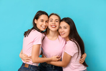 Poster - Portrait of beautiful hugging women on blue background. Women history month