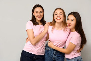 Wall Mural - Portrait of hugging women on grey background. Women history month