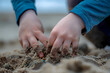  a child's hands building a sandcastle on the beach, the gritty texture of wet sand and the meticulous attention to detail a testament to the imaginative play and creativity of summertime