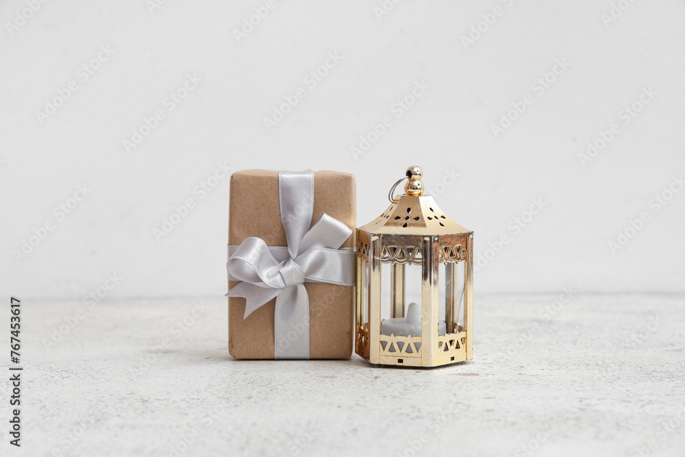 Gift box with Muslim lamp for Ramadan on white table