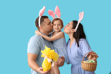 Wall Mural - Happy family in bunny ears with Easter decor on blue background