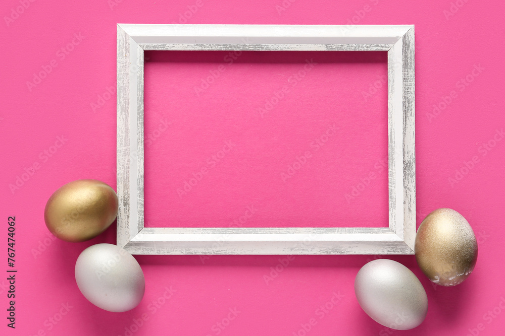 Beautiful composition with frame and painted Easter eggs on pink background
