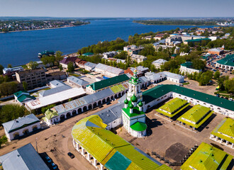 Wall Mural - Scenic view from drone of Kostroma cityscape on bank of Volga River with complex of provincial trading arcades (Gostiny Dvor), Russia..