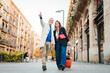 © Jose Calsina - Mature tourists pointing and walking with a suitcase on vacations. Middle aged couple having fun sightseeing on a european downtown. Real mid adult married people enjoying a journey trip on holidays.