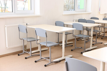 Wall Mural - Empty school classroom with desks and chairs