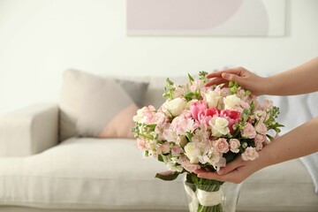 Wall Mural - Woman with beautiful bouquet of fresh flowers at home, closeup. Space for text