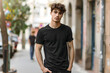 young Model Shirt Mockup, Boy wearing black t-shirt on street in daylight, Shirt Mockup Template on hipster adult for design print, Male guy wearing casual t-shirt mockup placement