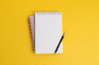 Simple to-do list planning year in notebook with pencil on yellow background 