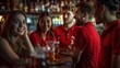 © Phoophinyo - A group of four young people wearing red shirts and beer glasses in a bar looked like they were enjoying the competition.