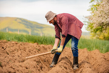 Sticker - Male farmer working on an agricultural fields in spring.