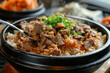 Korean Bulgogi Pork Rice on top with onsen york with someone put spoon in, hot steaming looking moist and very delicious