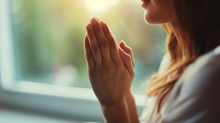 Close up of calm young Caucasian woman hold hands pray and feel grateful and thankful. Happy millennial female show gratitude, love and care, pray or visualize. Religion, faith concept.