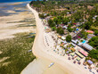 Aerial view of colorful sun loungers and parasols on a small tropical beach (Gili Islands, Lombok, Indonesia)