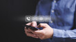 © TimmyTimTim - A man holding a smartphone and looking at a screen with icons for phone, email, voicemail, and text messaging for contact point.