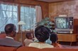 © blvdone - Old vintage photo of a family watching TV at home