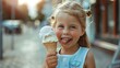 Funny little girl sticking out her tongue to taste an ice cream