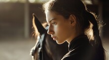 A Pensive Young Charming Girl, After Horse Riding, Thinks About Everyday Life. Close Portrait In Profile Of A Girl On A Blurred Background Of A Horse