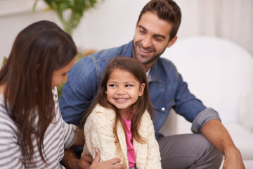 Poster - Home, sofa and family in living room with smile for bonding, support and childhood development. Happy, man and woman with little girl for holiday enjoyment, cheerful and relaxing on couch in house