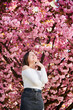 © anatoliy_gleb - Woman allergic enjoying after treatment from seasonal allergy at spring. Portrait of happy beautiful woman smiling in front of blooming sakura tree at springtime. Spring allergy concept.