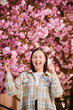© anatoliy_gleb - Woman allergic suffering from seasonal allergy at spring. Young happy woman applying allergy pill, posing in blossoming garden at springtime. Antihistamine medication concept