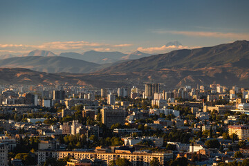 Sticker - View of Tbilisi from the surrounding hills. In the background you can see the Caucasus Mountains. A warm autumn day in the capital of Georgia.