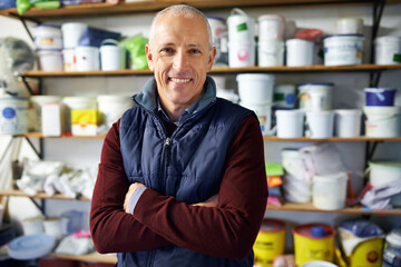 Canvas Print - Portrait, man and confidence of happy store owner in business or retail for plastic in startup. Face, arms crossed and mature professional in shop, entrepreneur and smile of manager in Switzerland