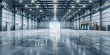 Fototapeta  - A large, empty warehouse with a lot of light shining on the floor. The space is very open and empty, with no people or objects visible. Scene is one of emptiness and solitude