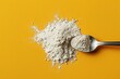 A spoon is on top of a pile of flour
