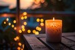 A candle is lit on a wooden table. The candle is surrounded by a white frame and is lit up, creating a warm and cozy atmosphere. The scene is set against a backdrop of a sunset