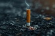 A cigarette is lit and smoking on the ground. Concept of danger and the potential harm of smoking