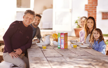 Poster - Happy family, portrait and breakfast in garden of home for nutrition, bonding or relax together with porridge. Parents, grandparents and child with healthy diet or meal at dining table in the morning