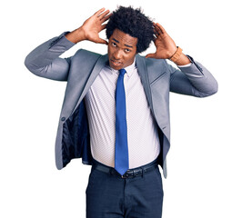 Wall Mural - Handsome african american man with afro hair wearing business jacket doing bunny ears gesture with hands palms looking cynical and skeptical. easter rabbit concept.