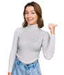 © Krakenimages.com - Young caucasian girl wearing casual clothes smiling with happy face looking and pointing to the side with thumb up.