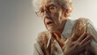 Senior elderly woman clutching her left chest from acute pain