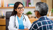 © Dave - A young female Asian doctor smiles and talks to an elderly male patient at her desk in her office