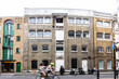 Blurry cyclists speed past old warehouses and workshops originally used in the leather industry that has long since departed this part of Southwark, south London, and is now a desirable neighbourhood