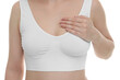 © New Africa - Mammology. Young woman doing breast self-examination on white background, closeup
