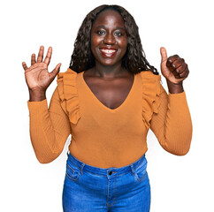 Sticker - Young african woman wearing casual clothes showing and pointing up with fingers number six while smiling confident and happy.