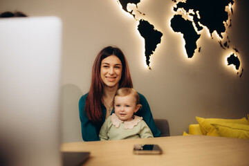 mother and daughter are choosing a tour in a travel agency