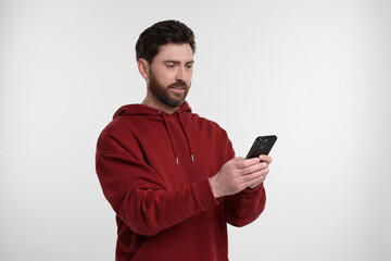 Poster - Handsome man with smartphone on white background