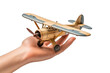 The Journey Begins: Hand Holding Toy Airplane. On a White or Clear Surface PNG Transparent Background.