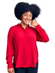 Wall Mural - Young african american girl wearing casual clothes smiling doing phone gesture with hand and fingers like talking on the telephone. communicating concepts.