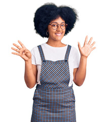 Sticker - Young african american girl wearing casual clothes showing and pointing up with fingers number nine while smiling confident and happy.