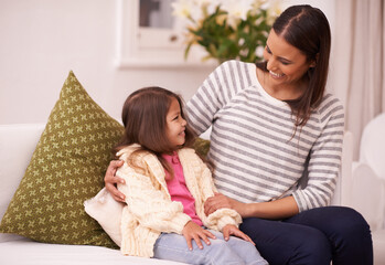 Sticker - Living room, mother and daughter talking with smile for embrace in home with love, care and happiness. Apartment, mom and girl in lounge to relax on sofa or couch with hug for bonding in family house