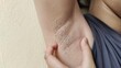 © Rung Kh - Portrait showing the fingers holding the flabbiness adipose sagging skin under the arm, armpit hair and wrinkle on the body of the woman, health care and beauty concept.