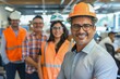 Diverse Team of Professional Engineers Smiling in Industrial Workspace with Safety Gear