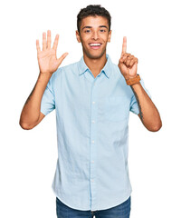 Canvas Print - Young handsome african american man wearing casual clothes showing and pointing up with fingers number six while smiling confident and happy.