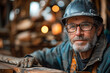 Man in hard hat and glasses in woodworking shop