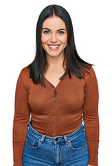 Wall Mural - Young hispanic woman wearing casual clothes with a happy and cool smile on face. lucky person.